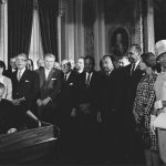 Lyndon B. Johnson signing the Civil Rights Act.