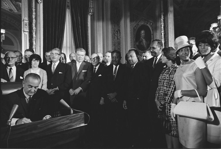 Lyndon B. Johnson signing the Civil Rights Act.